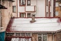 Smoke rises from the chimney on the house. Roof with smoking chimney in snowing winter