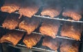 Smoke rising around a slow cooked beef brisket on a smoker barbecue grilling concept Royalty Free Stock Photo