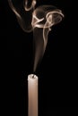 Smoke rising from an extinguished candle. Conceptual image
