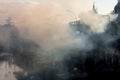 Smoke rising from the holy Bagmati River from cremations in Pashupatinah in Nepal.