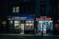 Smoke shop and laundromat on First Avenue at night, in the East Village, New York City