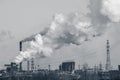 Smoke stacks in a working factory emitting steam