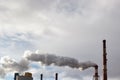 Smoke or steam coming out slowly of tall factory or power plant chimney