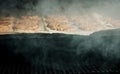 Smoke and steam rise from beef or meat barbecue