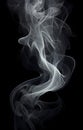 Smoke is steaming up against a black background, in the style of tenebrism Royalty Free Stock Photo