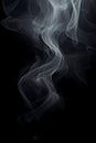 Smoke is steaming up against a black background, in the style of tenebrism Royalty Free Stock Photo