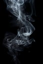 Smoke is steaming up against a black background, in the style of tenebrism Royalty Free Stock Photo