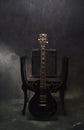 Smoke swirls out of moody lit stillife of black electric guitar and amp Royalty Free Stock Photo