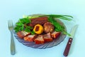 Smoked appetizing pork belly with vegetables on a plate Royalty Free Stock Photo