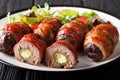 Smoked Armadillo eggs wrapped in bacon served with fresh salad close-up on the table. horizontal Royalty Free Stock Photo