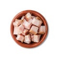 Smoked bacon cubes in a bowl isolated over white background Royalty Free Stock Photo