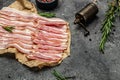 Smoked bacon strips meat slice thin slicing pork fat meal on a black background, ketogenic diet, place for text, top view Royalty Free Stock Photo