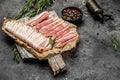 Smoked bacon strips meat slice thin slicing pork fat meal on a black background, ketogenic diet, place for text, top view