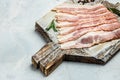 Smoked bacon strips meat slice thin slicing pork fat meal on a light background, ketogenic diet, place for text, top view