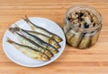 Smoked baltic herring on saucer and preserved in oil Royalty Free Stock Photo