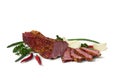 Smoked beef with pieces and spice, bulb onion and green leaves onion, parsley, red pepper on white background