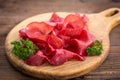 Smoked beef prosciutto, sliced bresaola on a wooden board