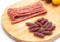 Smoked beer snack thin mini sausages wooden background. Close-up