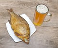 Smoked bream and a glass of beer on a wooden table Royalty Free Stock Photo