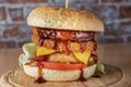 smoked chickenburger centred on wooden plate close up