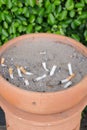 Smoked cigarettes in a dirty ashtray Royalty Free Stock Photo