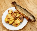 Smoked fish and backed potatoes Royalty Free Stock Photo