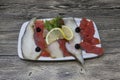 Smoked fish delicacies from the Northern seas halibut, salmon.Slices of smoked salmon and halibut on a plate with a slice of lemon Royalty Free Stock Photo