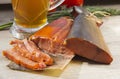 Smoked fish and a glass of beer on a wooden background Royalty Free Stock Photo