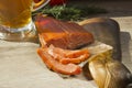 Smoked fish and a glass of beer on a wooden background Royalty Free Stock Photo