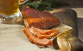 Smoked fish and a glass of beer on a wooden background Royalty Free Stock Photo