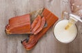 Smoked fish and a glass of beer on a wooden background Royalty Free Stock Photo