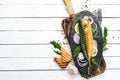 Smoked fish mackerel with onion and lemon on a black plate. Top view. Free space for your text. Royalty Free Stock Photo