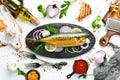 Smoked fish mackerel with onion and lemon on a black plate. Top view. Free space for your text. Royalty Free Stock Photo