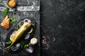 Smoked fish mackerel with onion and lemon on a black plate. Top view. Free space for your text. Royalty Free Stock Photo