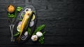 Smoked fish mackerel with onion and lemon on a black plate. Top view. Royalty Free Stock Photo