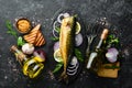 Smoked fish mackerel with onion and lemon on a black plate. Top view. Free space for your text. Royalty Free Stock Photo