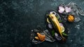 Smoked fish mackerel with onion and lemon on a black plate. Top view. Royalty Free Stock Photo