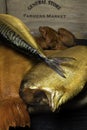 Smoked fish, mackerel, sig, perch and cod roe on the black wooden table Royalty Free Stock Photo