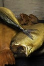 Smoked fish, mackerel, sig, perch and cod roe on the black wooden table. Omega 3 source. Polyunsaturated fats