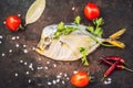 Smoked fish Vomero and spices on an old black table Royalty Free Stock Photo