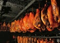 Smoked ham, bacon and sausages hang on hooks in a smokehouse in Germany, Schleswig-Holstein