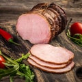 Smoked ham on a chopping board. Cutted Ham Sausage on wooden background Royalty Free Stock Photo