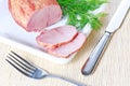 Smoked ham and dill on plate with knife and fork Royalty Free Stock Photo