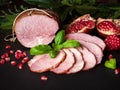 Smoked ham with herbs, fruits pomegranate