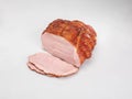 Smoked ham - in one piece and sliced, isolated on a white background. Polish cold cuts, a packshot photo. Royalty Free Stock Photo