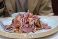 Smoked ham pieces on plate with fork, savory roasted meat served casually and appetizingly Royalty Free Stock Photo