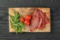 Smoked ham prsut with cherry tomatoes and arugula