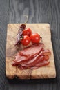 Smoked ham prsut with cherry tomatoes and chili