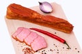 Smoked ham with red onion on a white wooden plate Royalty Free Stock Photo