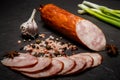 Smoked ham sausage with sliced pieces, garlic and onion Royalty Free Stock Photo